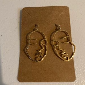 Gold plated face earrings, new on card